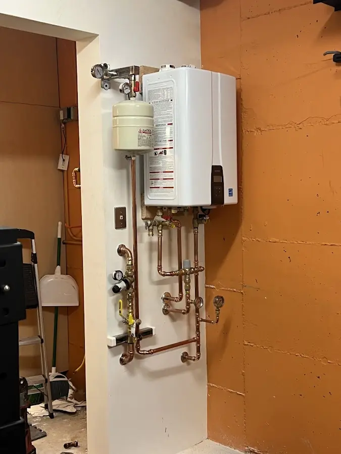 Plumbing technician inspecting water heater connections in Gibsonton